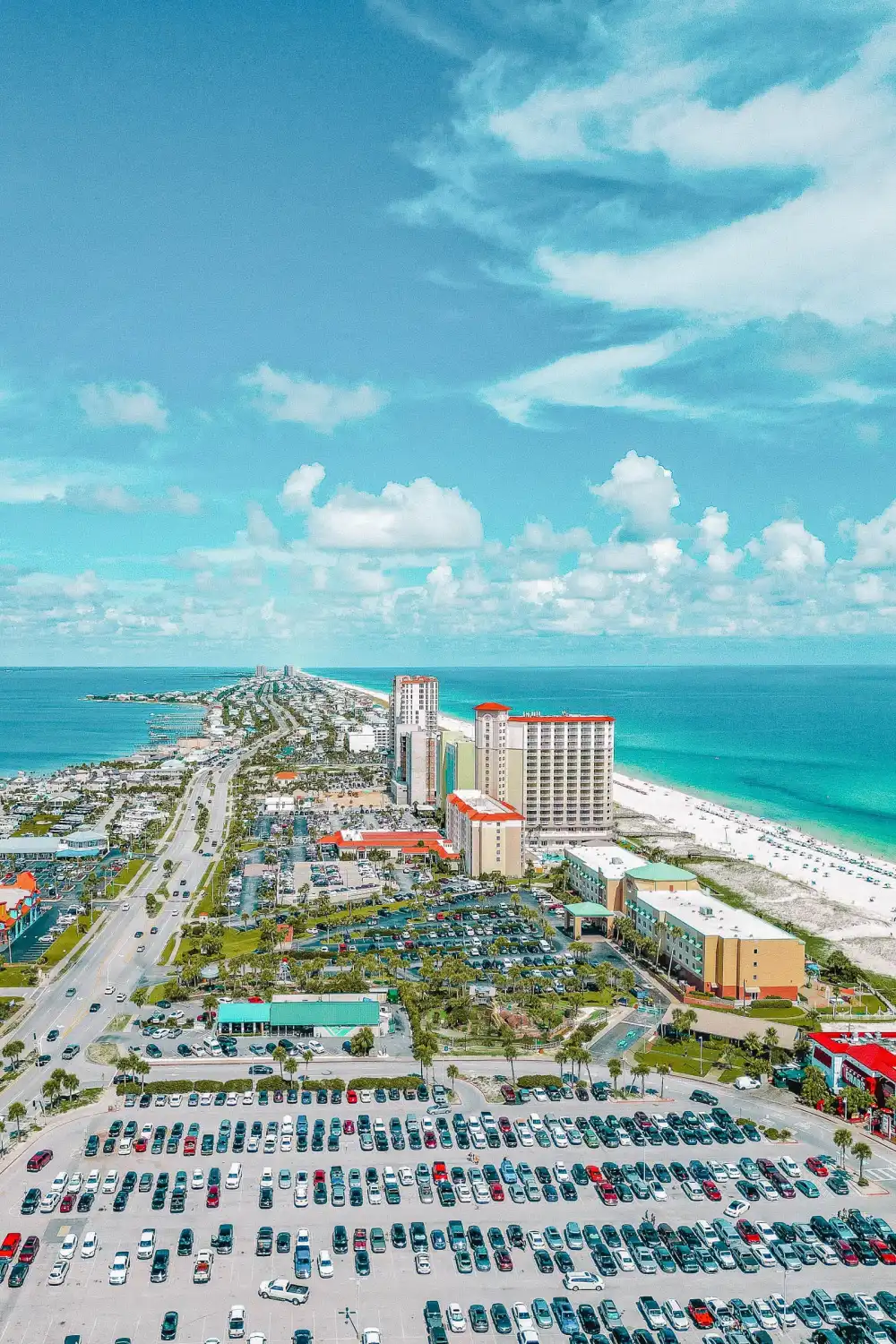 Aerial view of beachfront city, hotels, and turquoise ocean